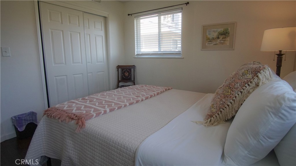 701 Williams Avenue Madera, CA 93637 - Photo 16 of 20 a bedroom with a bed and a lamp on dresser