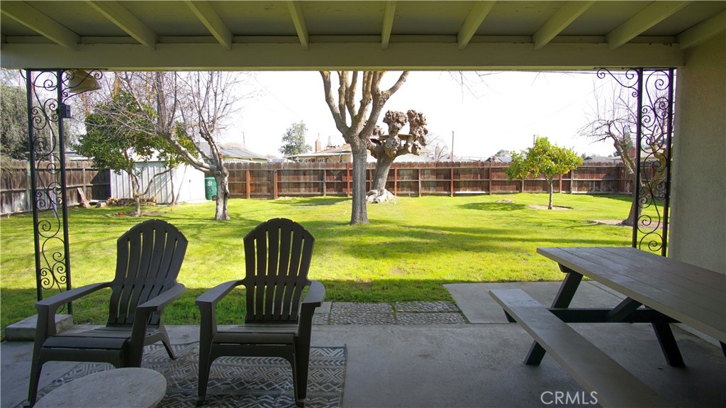 701 Williams Avenue Madera, CA 93637 - Photo 18 of 20 a view of a swimming pool with lawn chairs under an umbrella