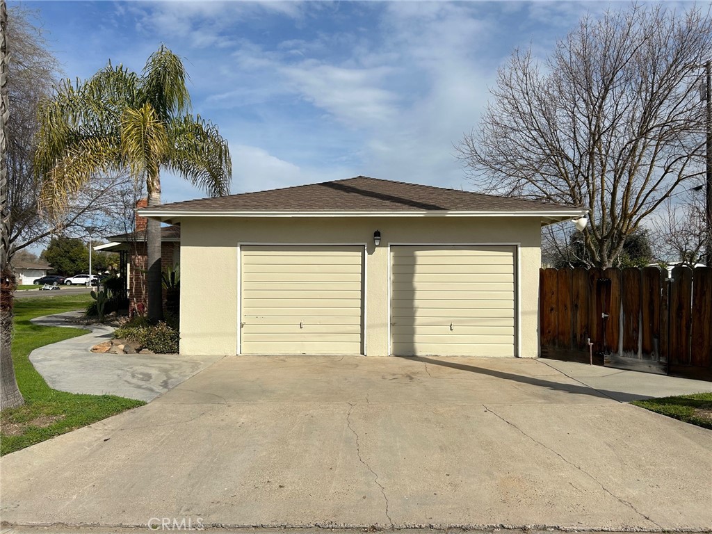 701 Williams Avenue Madera, CA 93637 - Photo 3 of 20 a front view of a house with a yard and garage