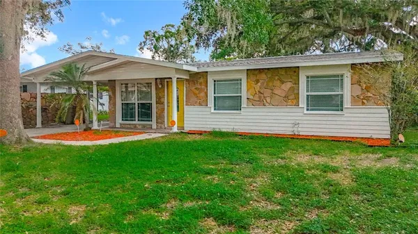a view of a house with a backyard