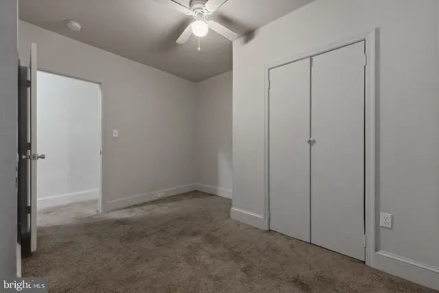 an empty room with closet area