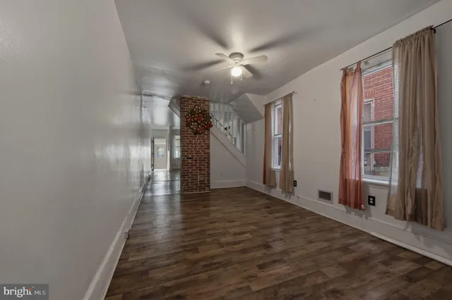 a view of a hallway with wooden floor