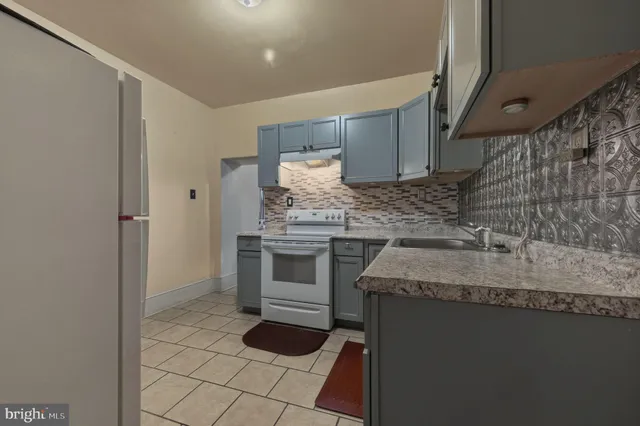 a kitchen with a sink and a stove top oven