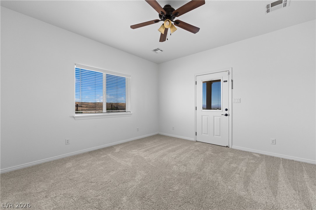 575 Gann Avenue Logandale, NV 89021 - Photo 23 of 75 A well-lit room featuring a private exterior door and plush carpeting for comfort.