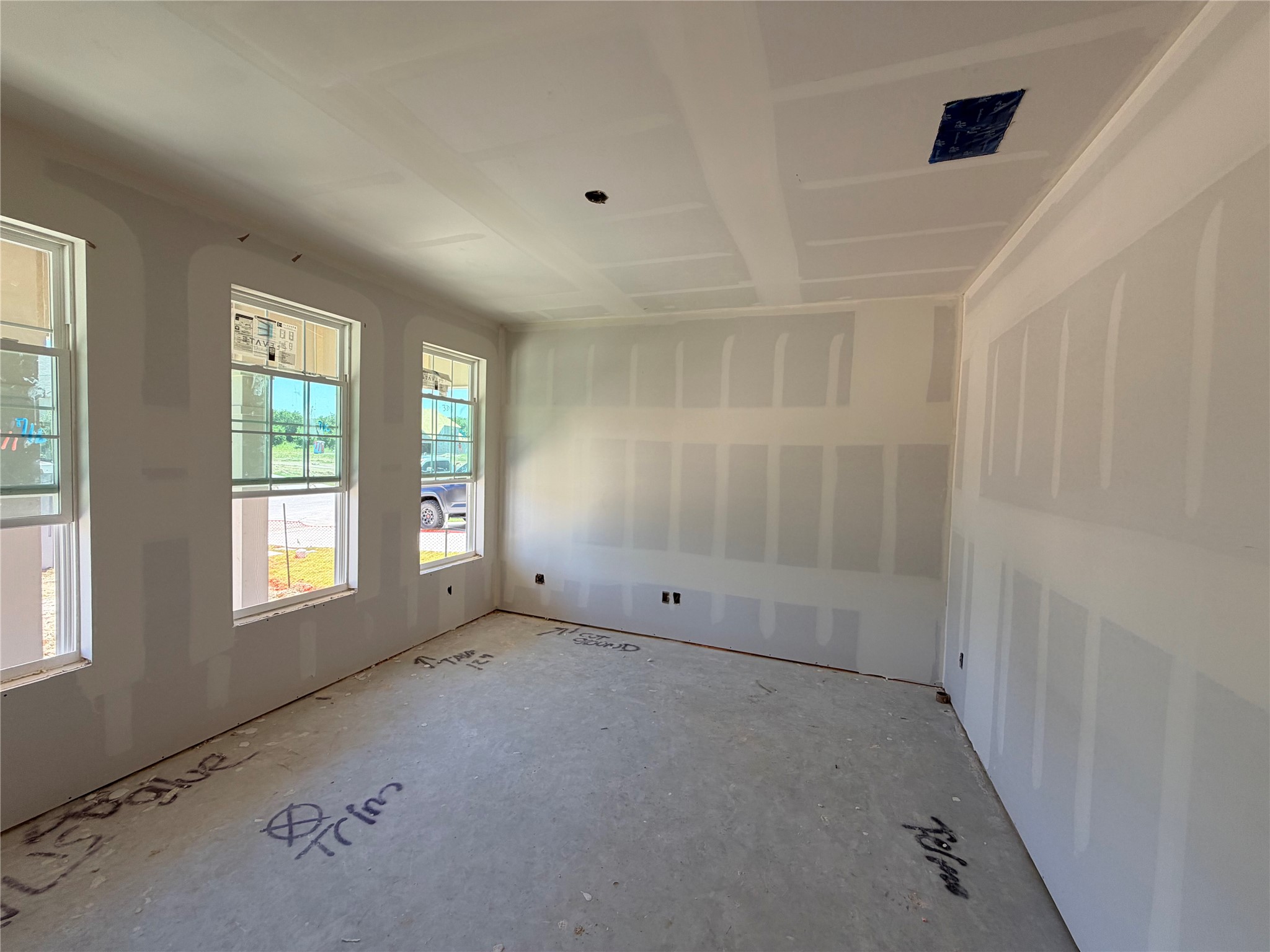 254 Gus Loop Georgetown, TX 78626 - Photo 2 of 16 An unfinished room awaits personalized touches, offering a versatile space with ample natural light.