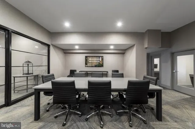a view of a hallway with a livingroom and a mirror
