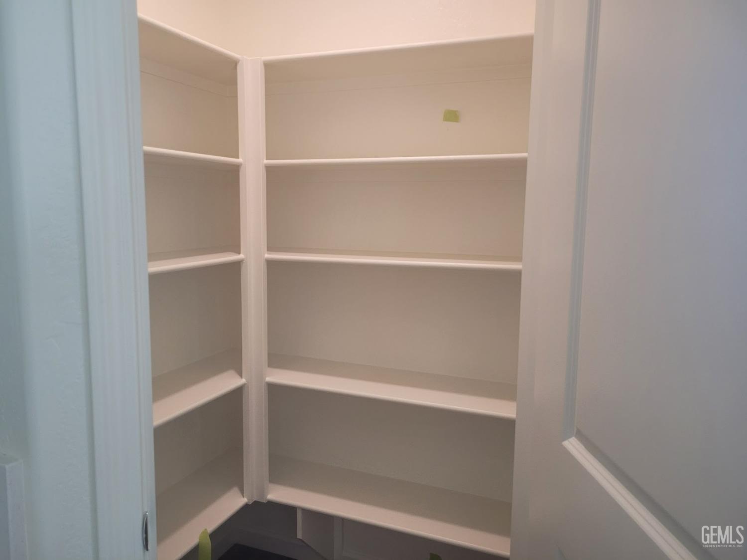 Undisclosed Address Bakersfield, CA 93307 - Photo 9 of 24 a view of walk in closet with empty racks