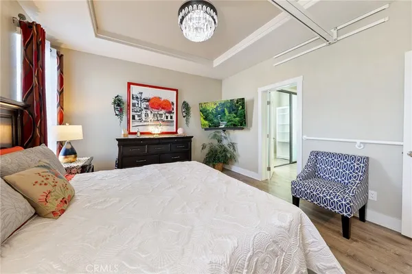 a bedroom with a bed and a chandelier