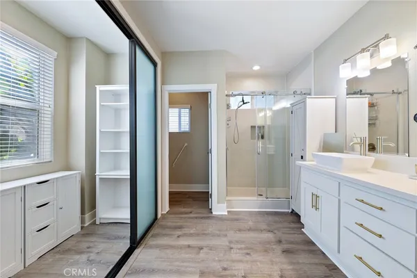 a bathroom with a double vanity sink mirror and shower