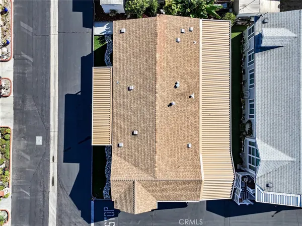 a view of a house with a yard and potted plants