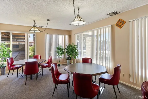 a room with stainless steel appliances kitchen island granite countertop a refrigerator and a stove top oven