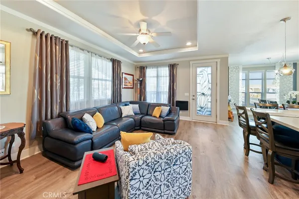 a living room with furniture fireplace and a large window