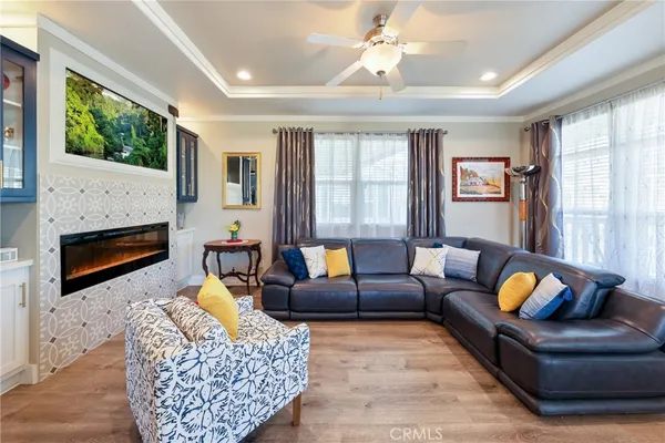 a living room with furniture a chandelier and a large window