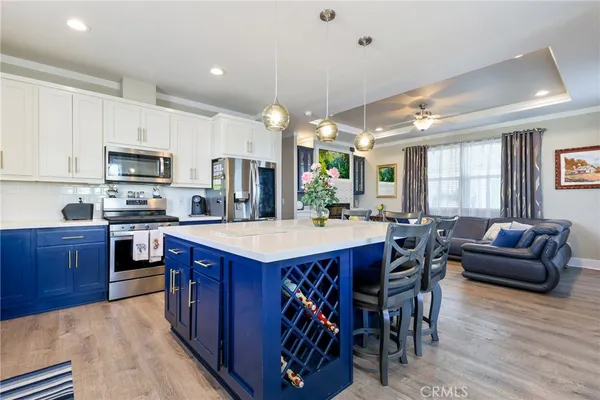 a kitchen with a sink cabinets and wooden floor