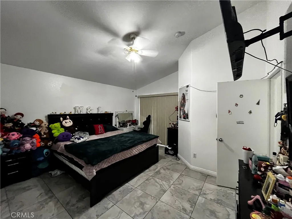 1208 North Fillmore Avenue Rialto, CA 92376 - Photo 14 of 19 a bedroom with furniture and a flat screen tv