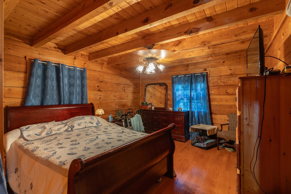 200 Lickskillet Road Epworth, GA 30541 - Photo 3 of 51 a bedroom with a bed and wooden floor