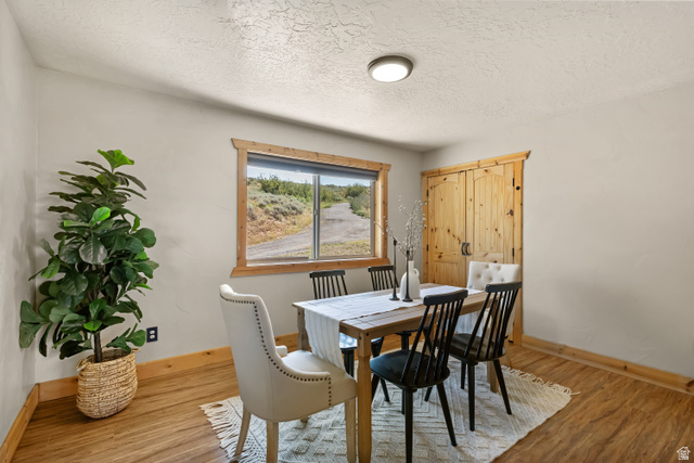 2013 North River View Road Huntsville, UT 84317 - Photo 15 of 53 Dining area featuring wood finished floors and a textured ceiling