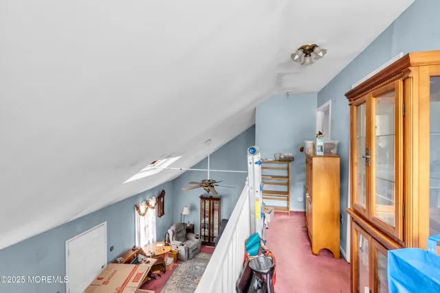 a view of a livingroom with wooden floor and furniture