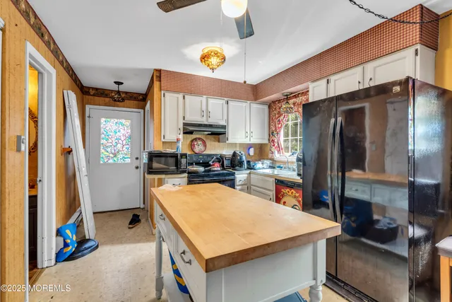 a kitchen with a refrigerator a stove and a sink
