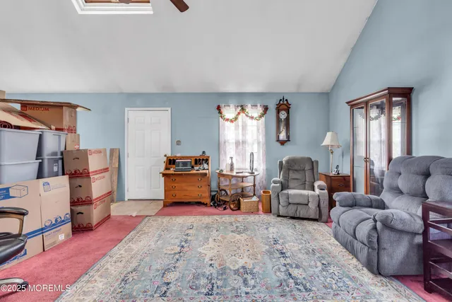 a living room with furniture and a dining table
