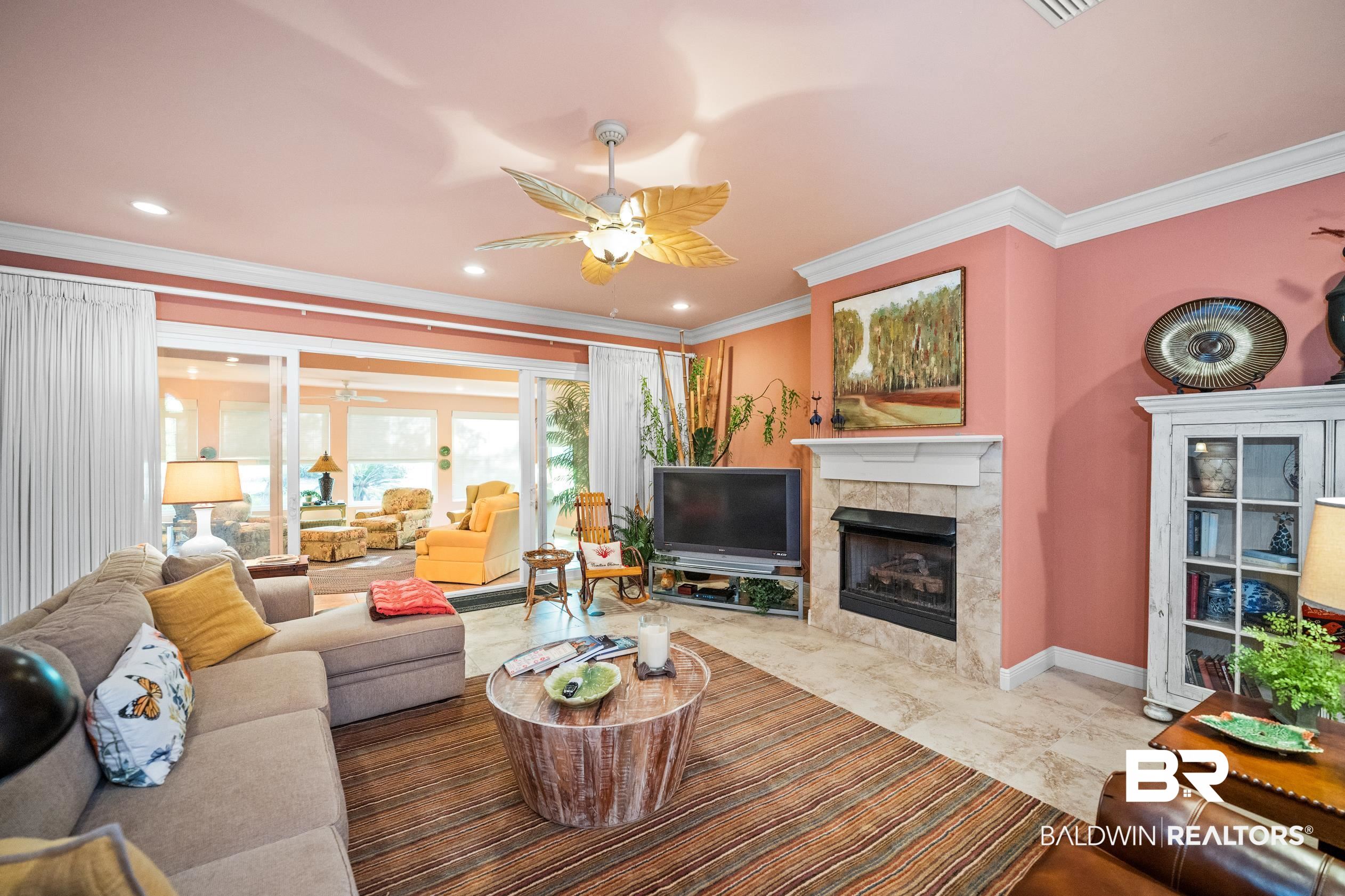 404 Peninsula Boulevard Gulf Shores, AL 36542 - Photo 3 of 51 Living area featuring a ceiling fan, ornamental molding, a fireplace, marble finish floors, and recessed lighting