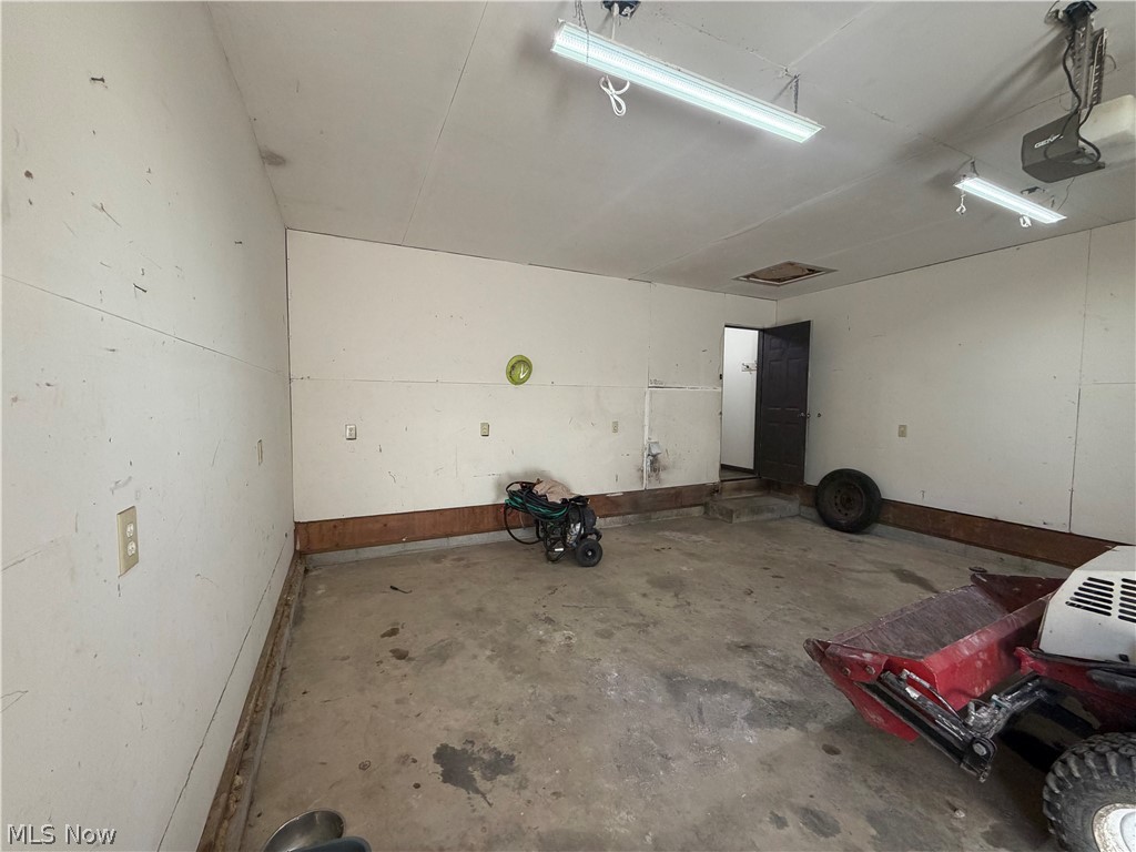 3950 Wolf Road Southwest Port Washington, OH 43837 - Photo 19 of 45 Concrete flooring with wall paneling and overhead fluorescent lighting