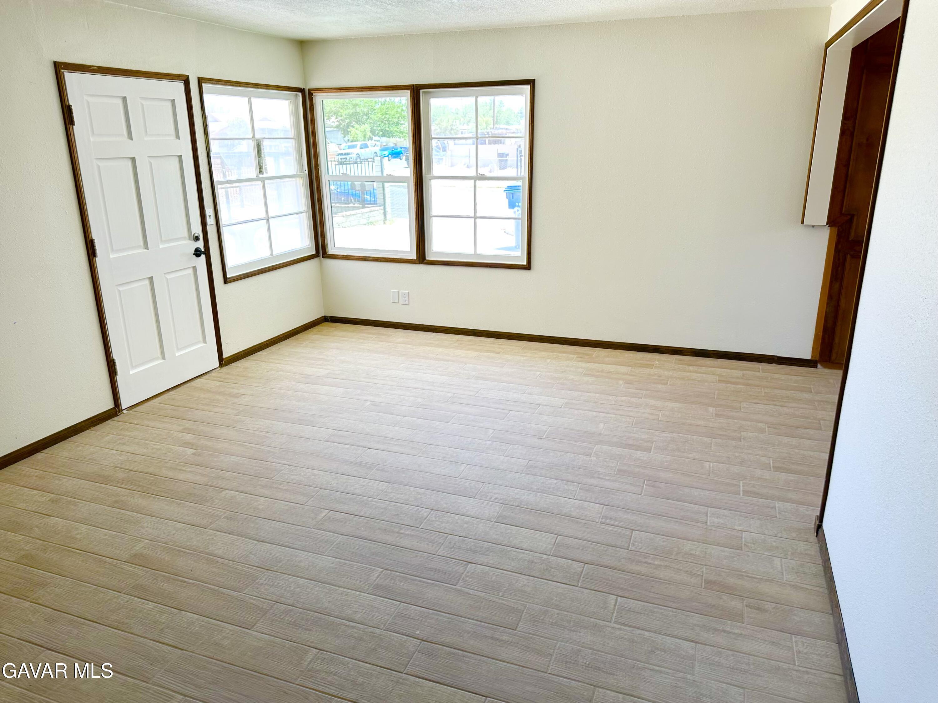 839 East Ave P-12 Palmdale, CA 93550 - Photo 3 of 9 a view of an empty room with a window and hardwood floor