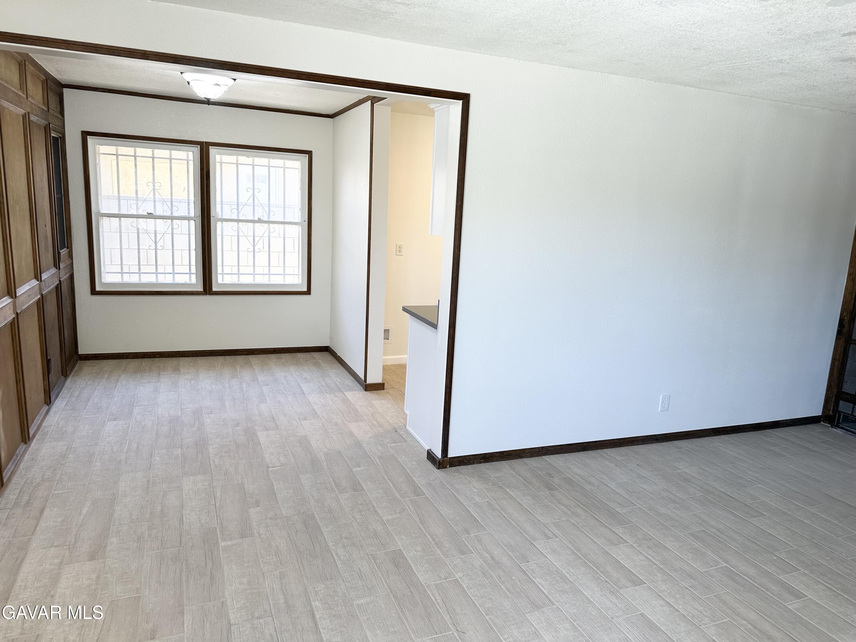 839 East Ave P-12 Palmdale, CA 93550 - Photo 6 of 9 an empty room with wooden floor and windows