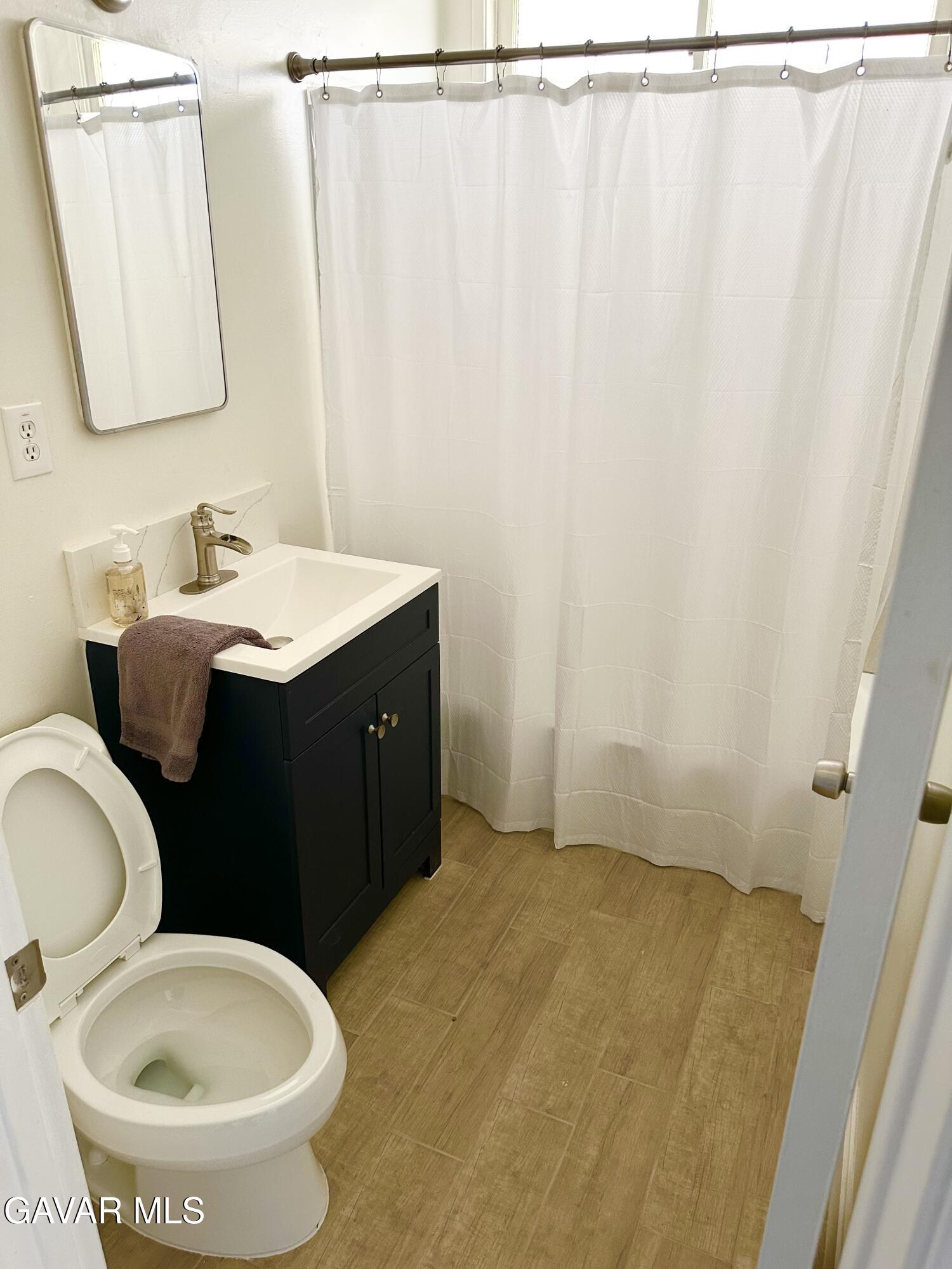 839 East Ave P-12 Palmdale, CA 93550 - Photo 8 of 9 a bathroom with a granite countertop sink and a mirror
