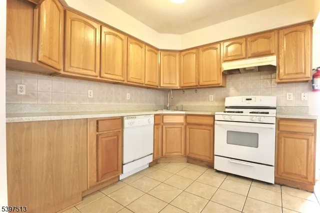 a kitchen with granite countertop cabinets stainless steel appliances and a sink