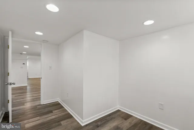 a view of hallway with wooden floor
