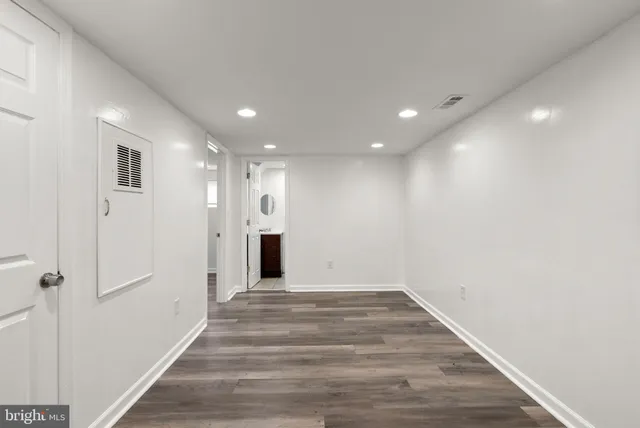a view of a hallway with wooden floor