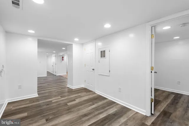 a view of a hallway with wooden floor