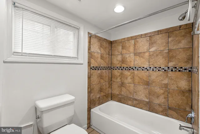 a bathroom with a toilet and shower