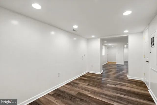 a view of a room with wooden floor