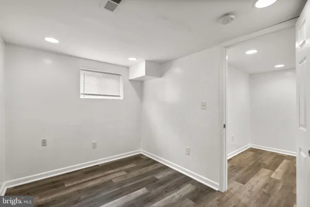 a view of a room with wooden floor
