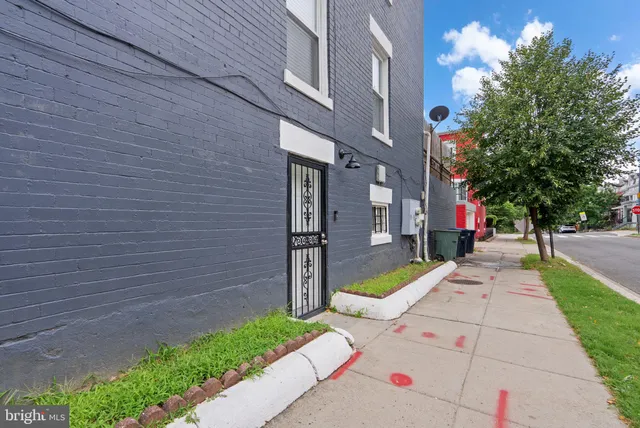 a view of a pathway of a house with a yard