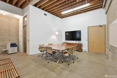 a view of a livingroom with furniture and a flat screen tv