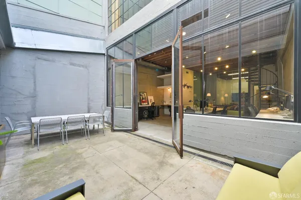 a view of a chairs and table in a patio