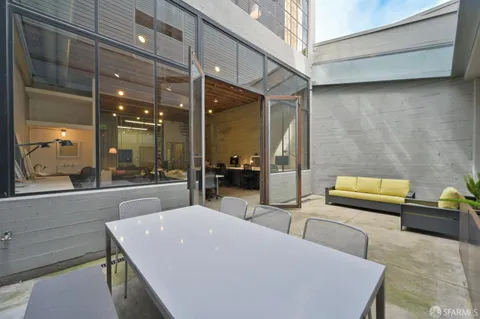 a large living room with stainless steel appliances kitchen island granite countertop furniture and a view of living room
