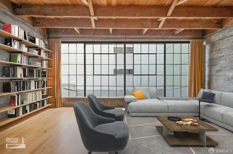 a living room with furniture and a book shelf