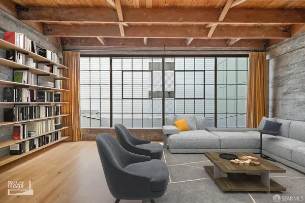 a living room with furniture and a book shelf