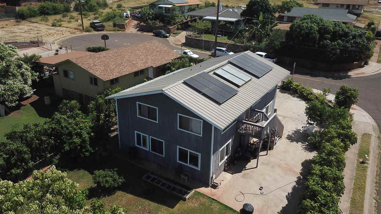 an aerial view of a house with a yard and balcony