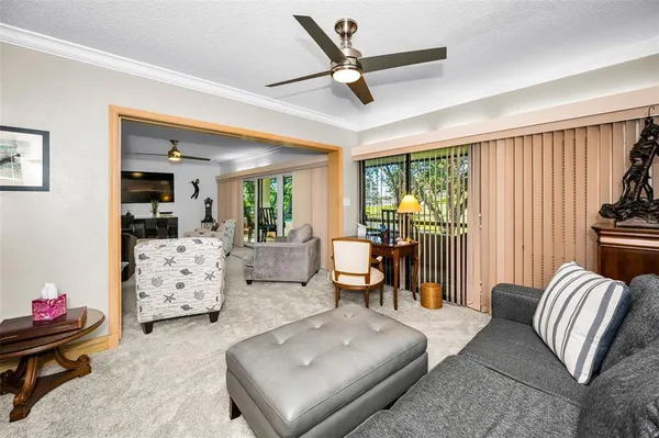 a view of a dining room with furniture and a chandelier