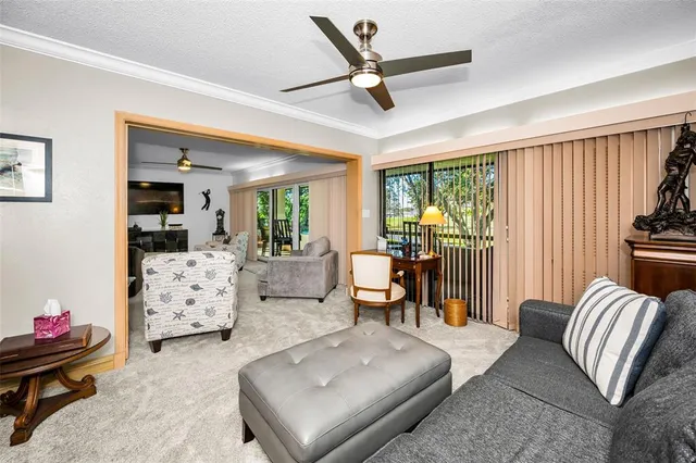 a view of a dining room with furniture and a chandelier