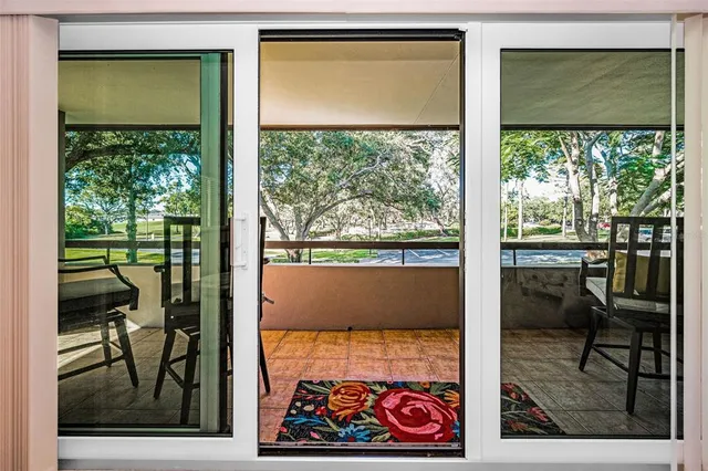 a view of an house with backyard and trees