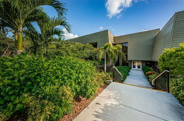 a front view of a building with a garden