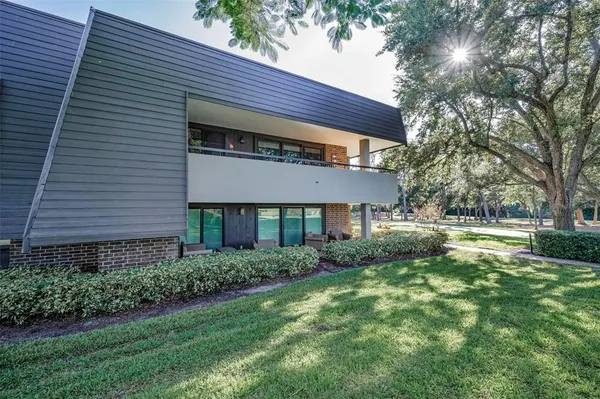 a living room with furniture a flat screen tv and a large window