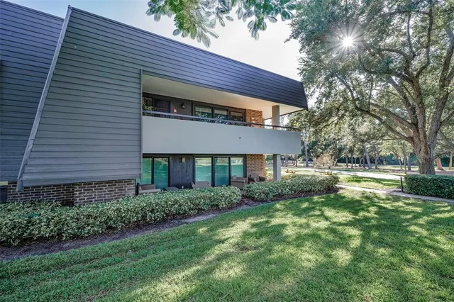 a living room with furniture a flat screen tv and a large window