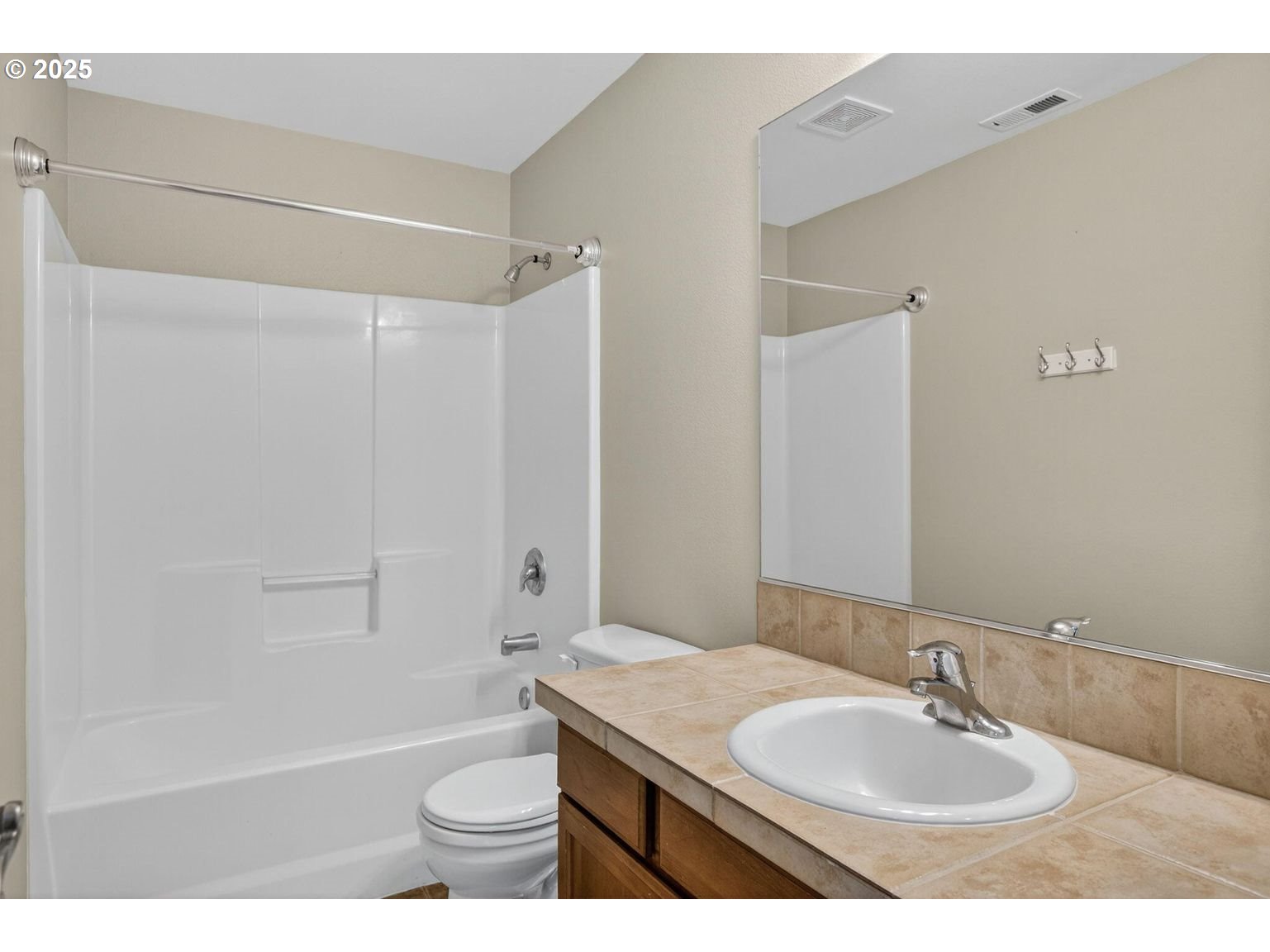 21154 Ritz Place Bend, OR 97702 - Photo 16 of 24 a bathroom with a sink a toilet and shower